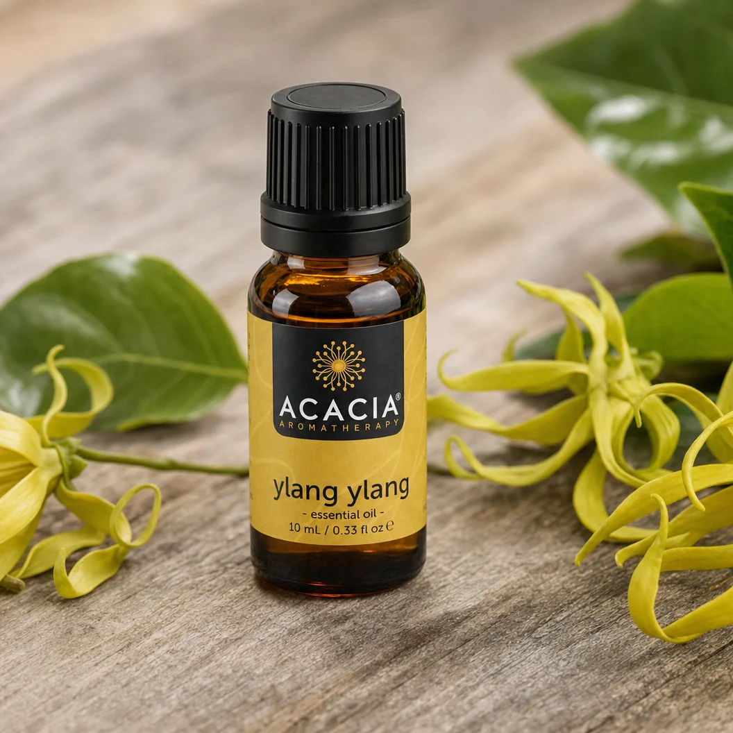 Ylang Ylang First Pure Essential Oil 10mL lifestyle – Acacia Aromatherapy bottle with ylang ylang flowers on wooden surface, Australia