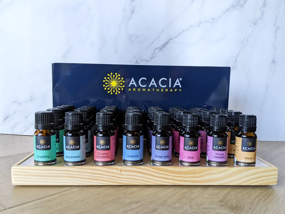 Acacia Aromatherapy signature display stand with timber base and essential oil range